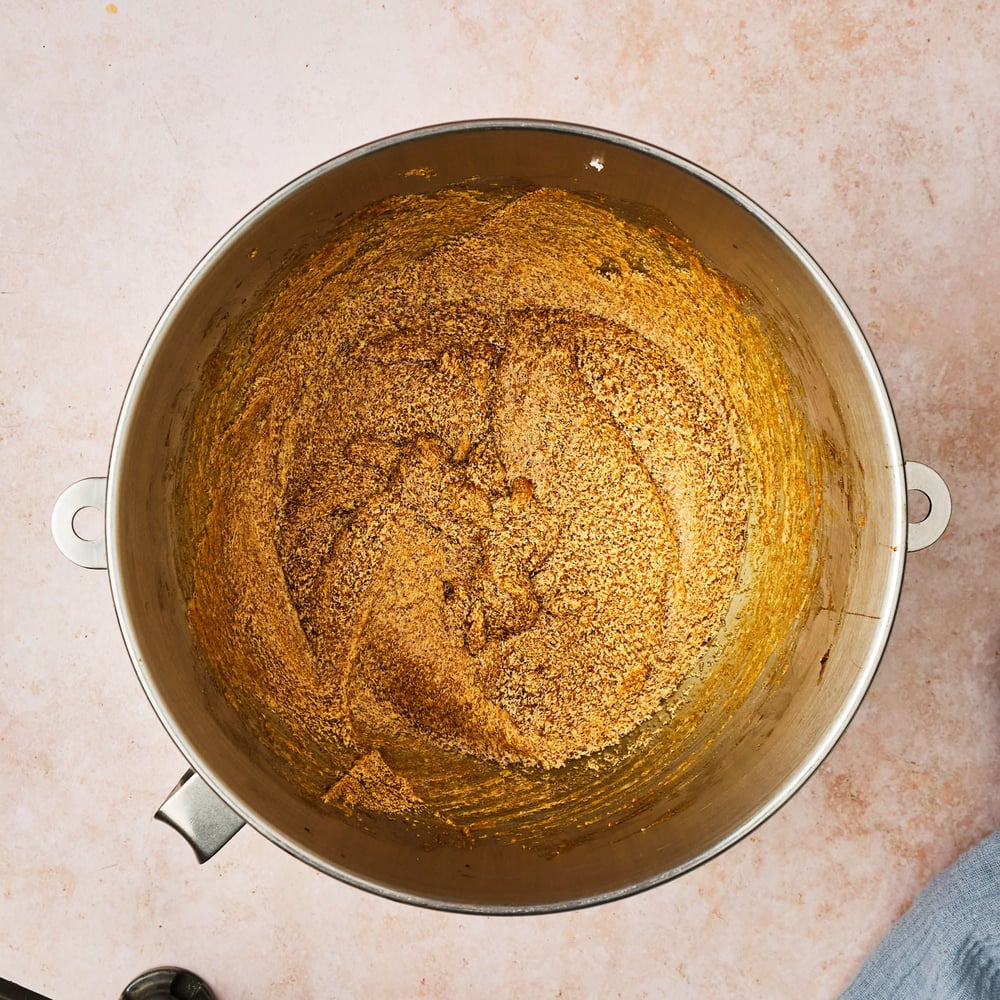 The wet ingredients for vegan ginger cookies, mixed in the bowl of a stand mixer.
