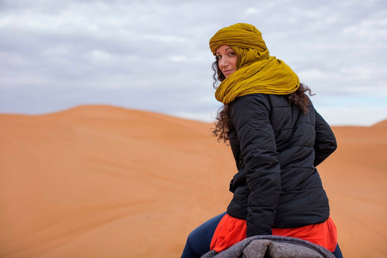 Riding on a camel through the sand dunes