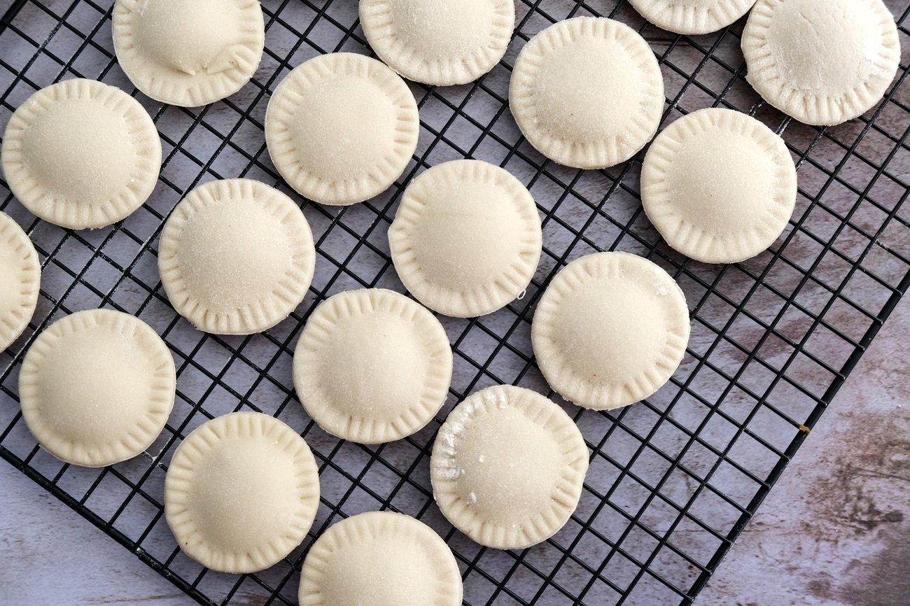You should let your ravioli dry for about an hour before boiling them.