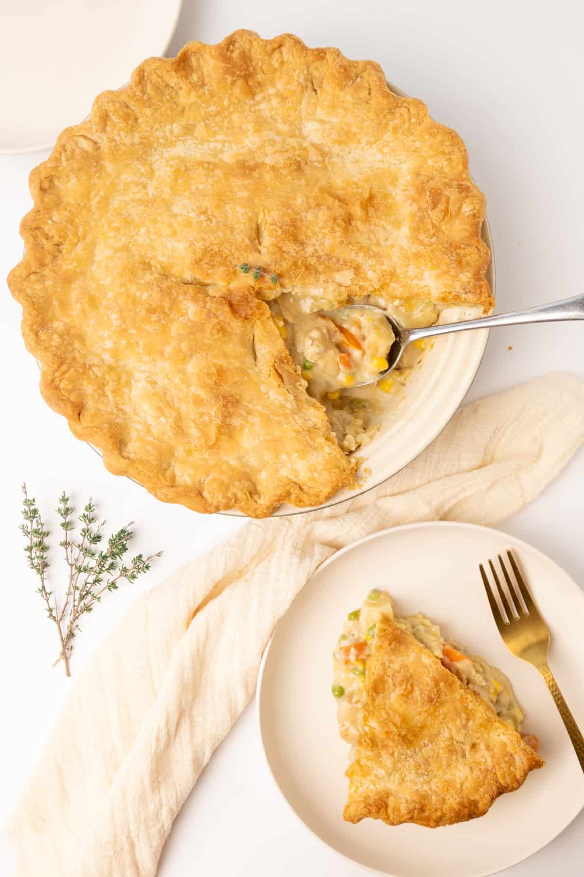 A vegan pot pie with a slice served on a plate. 