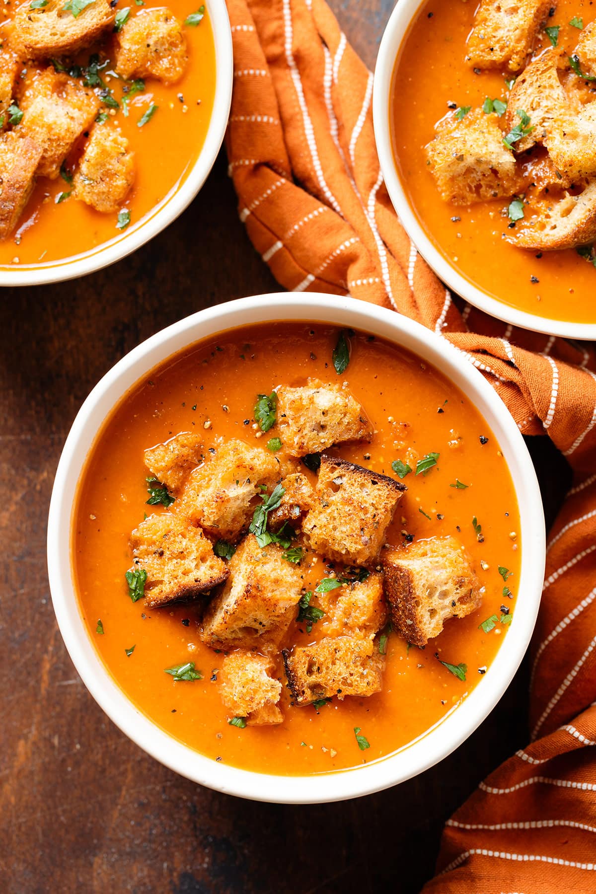 Three bowls of white bean tomato soup.
