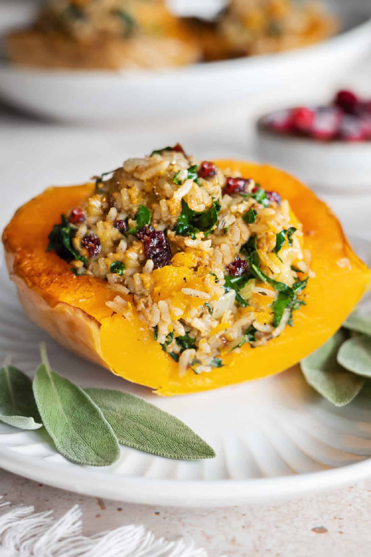 Vegan Stuffed Butternut Squash on a plate with sage leaves.