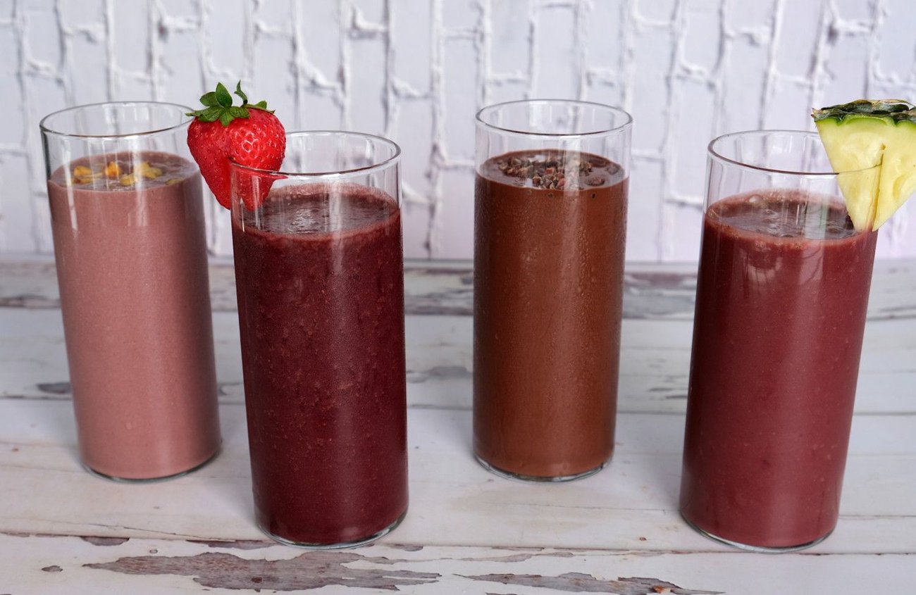 From left to right: PB & Açaí Smoothie, Strawberry Açaí Smoothie, Chocolate Açaí Smoothie, and Pineapple-Ginger Açaí Smoothie