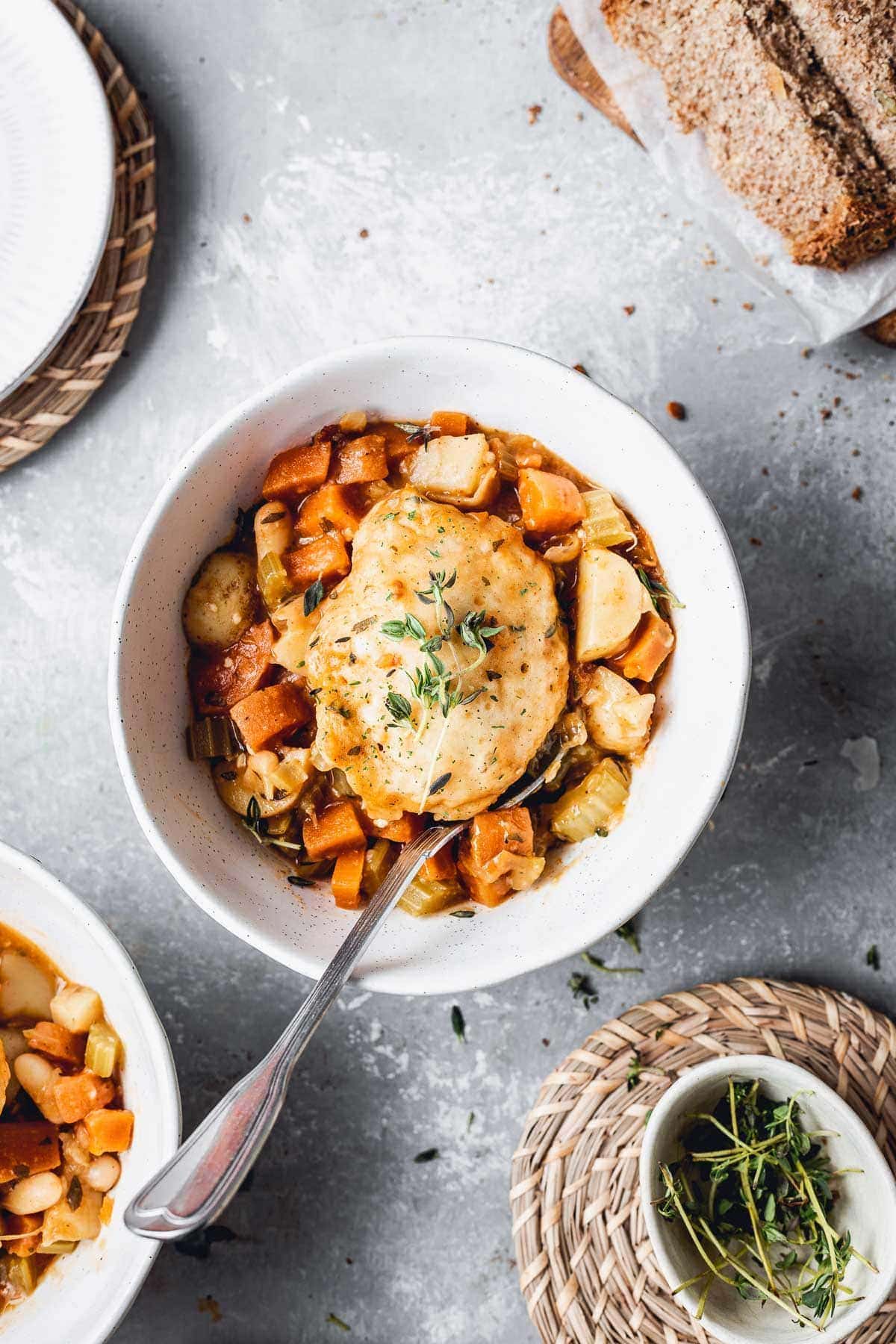 A bowl of vegan stew and dumplings.