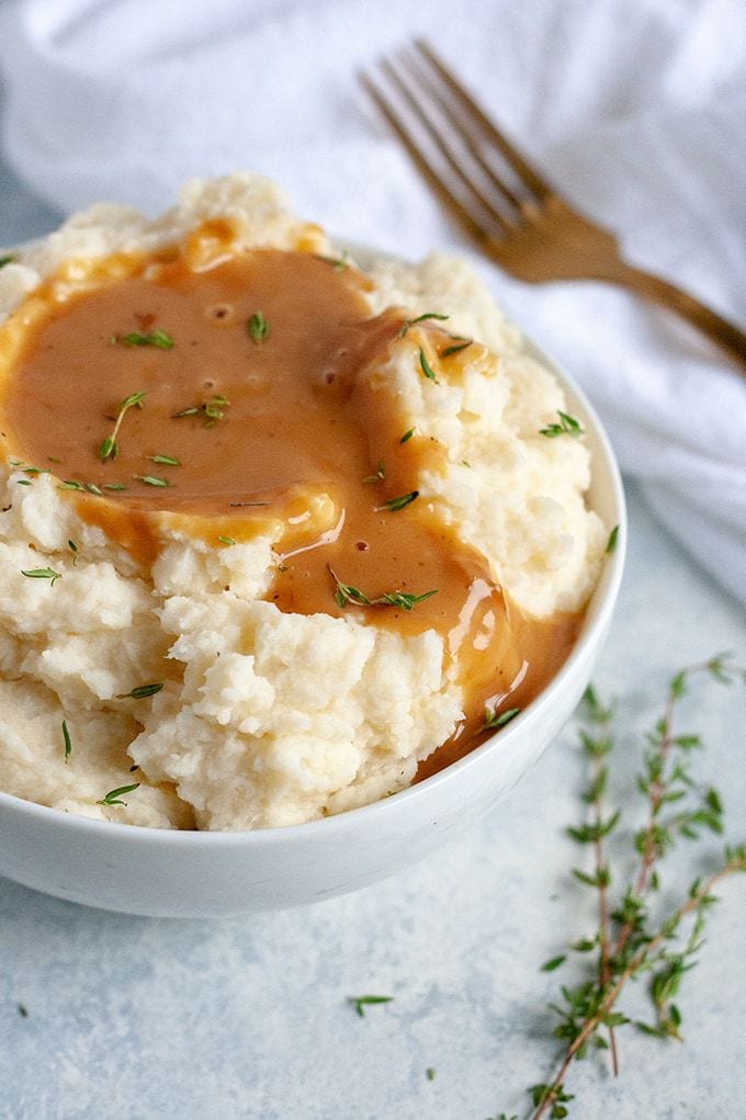 Vegan mashed potatoes in a bowl with gravy.