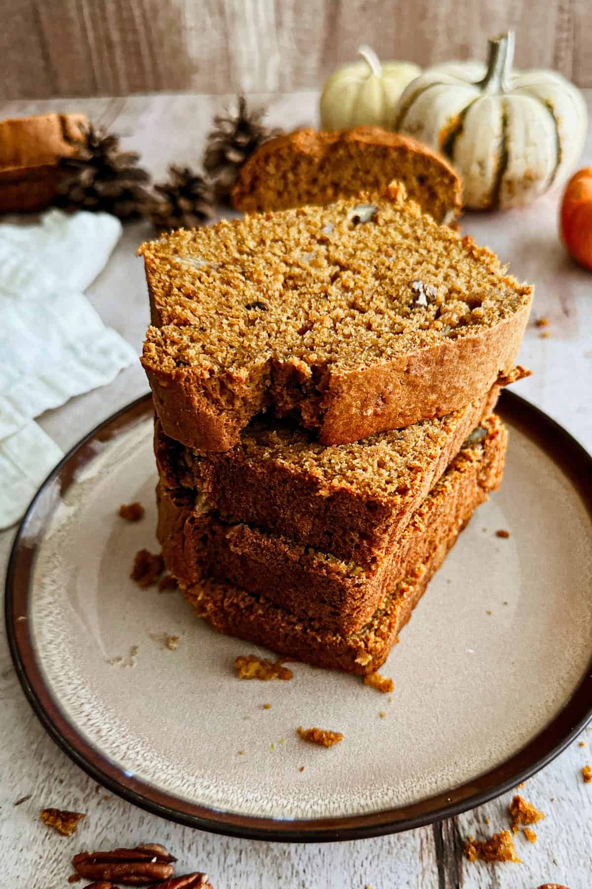 Slices of vegan banana pumpkin bread on a plate.