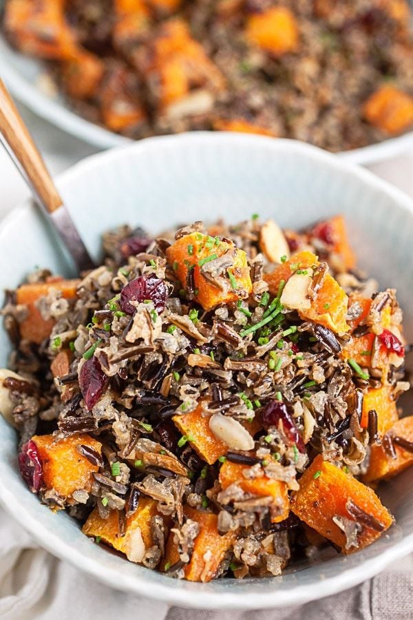 Fall harvest wild rice salad in a bowl with a spoon.
