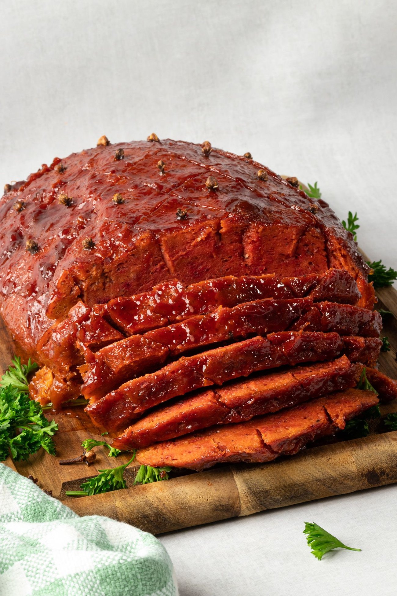 Vegan ham, sliced on a platter.