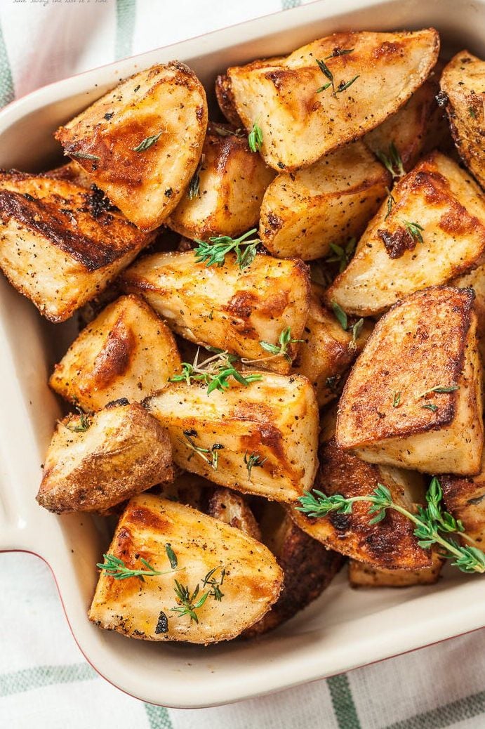 Garlic herb roasted potatoes in a casserole dish. 