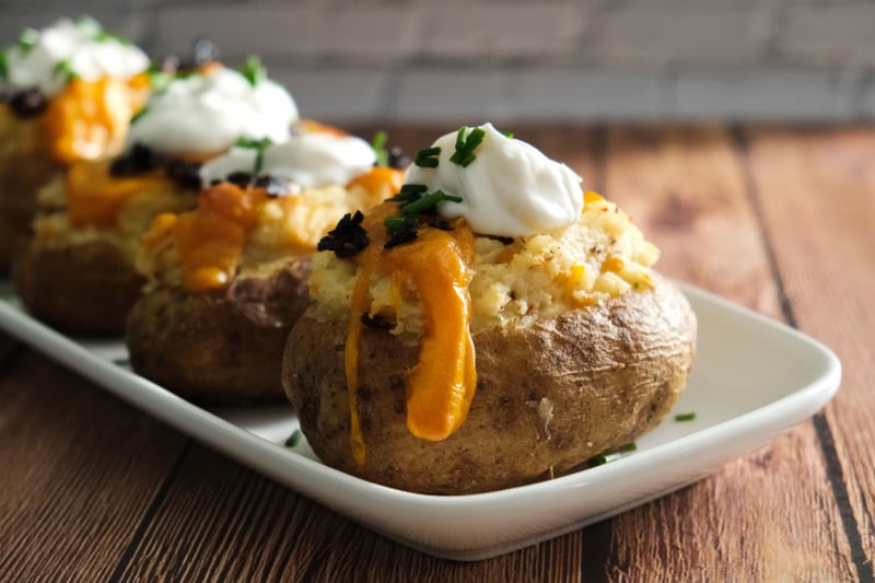 Vegan loaded baked potatoes on a platter