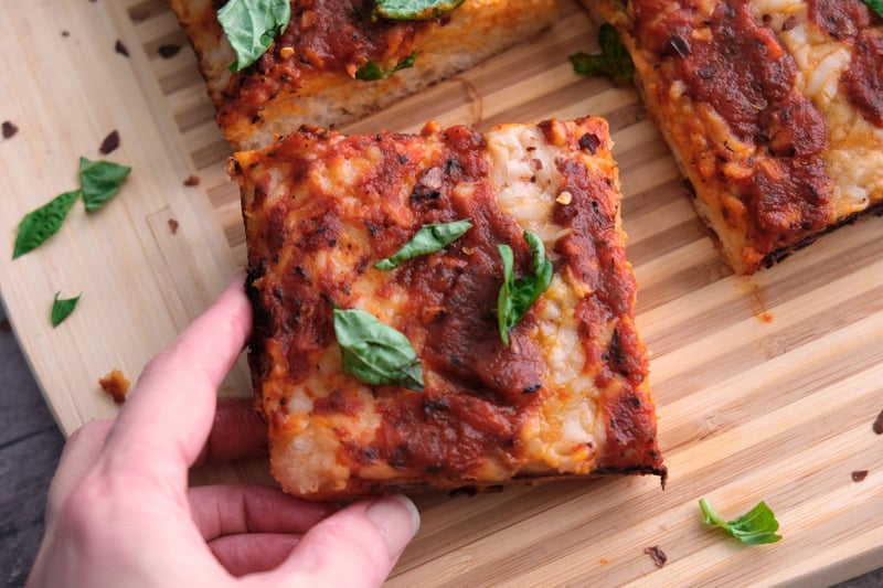 Picking up a slice of pizza