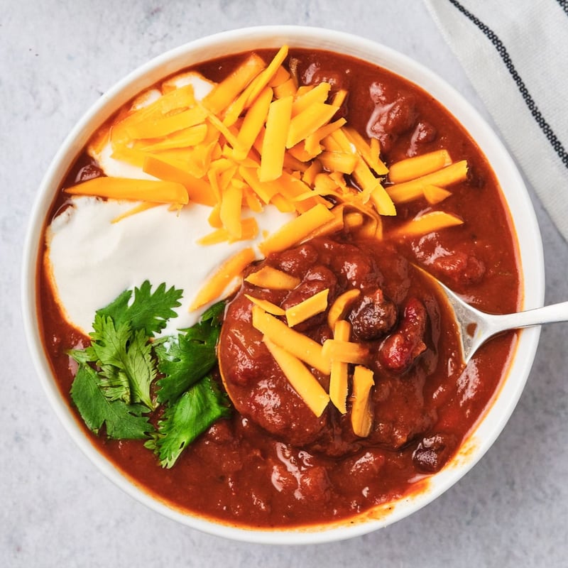 Vegan chili in a bowl with a spoon. 