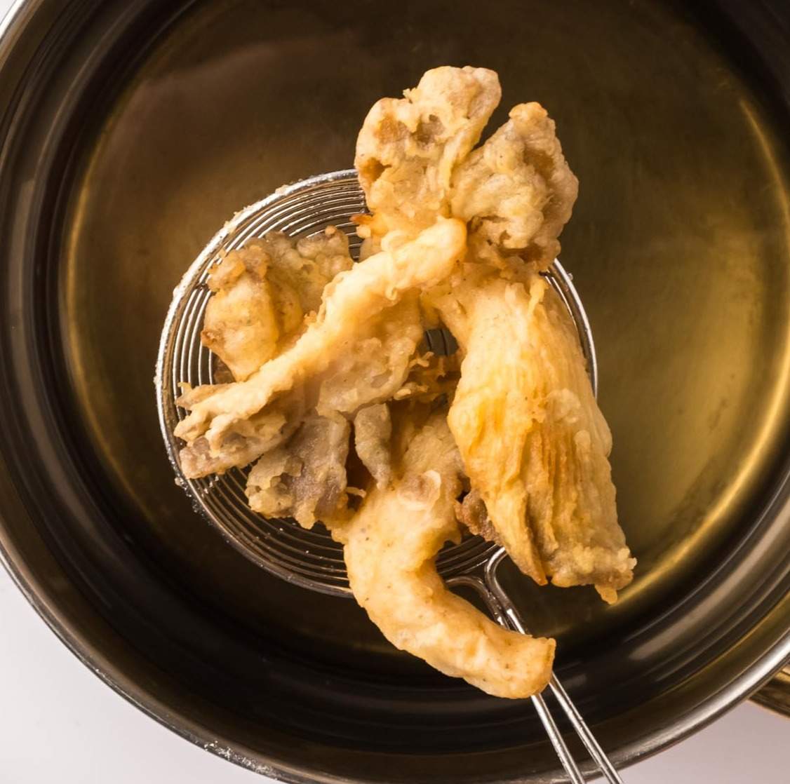 Oyster mushrooms fried, coming out of the frying pan.